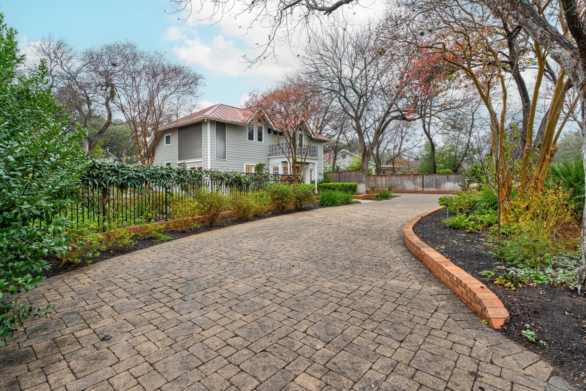 1502 Murray Lane Austin, TX 78703 - Photo 3 of 33 a front view of a house with a yard and shrubs