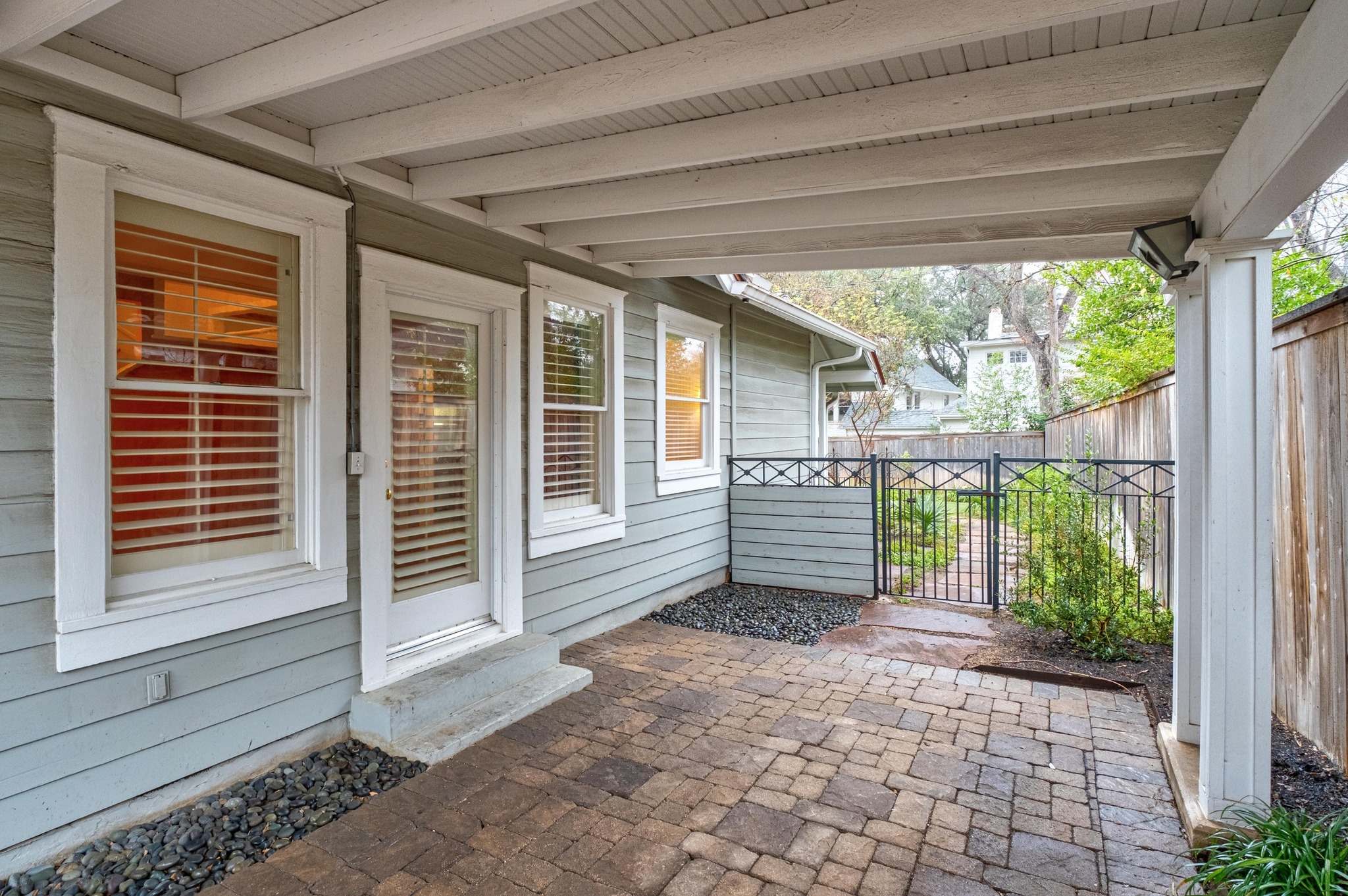 1502 Murray Lane Austin, TX 78703 - Photo 32 of 33 a view of a house with a large window and wooden fence