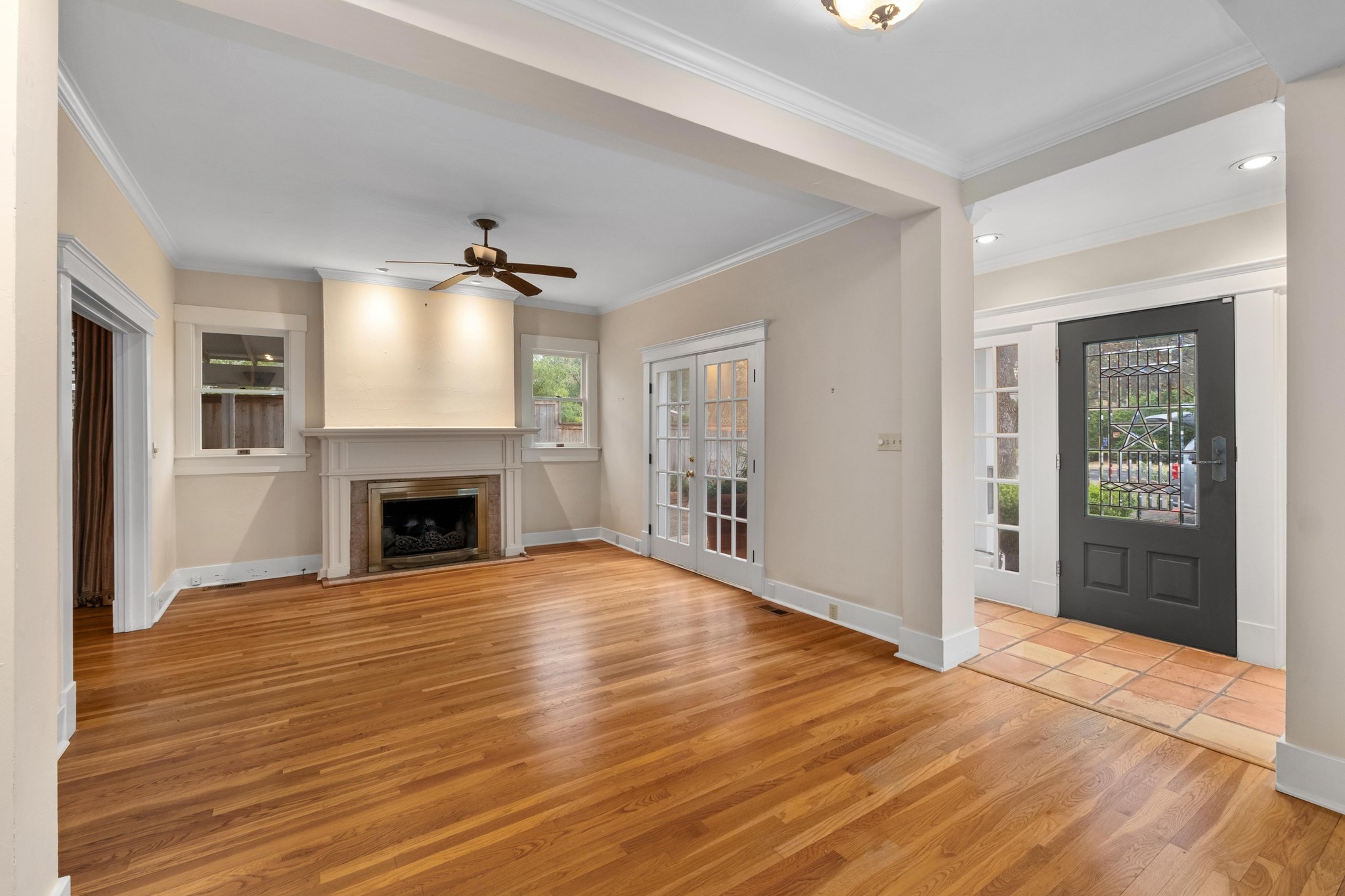 1502 Murray Lane Austin, TX 78703 - Photo 5 of 33 a view of an empty room with wooden floor fireplace and a window