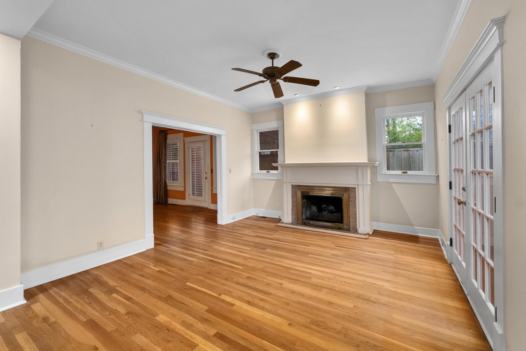 1502 Murray Lane Austin, TX 78703 - Photo 6 of 33 a view of an empty room with wooden floor fireplace and a window