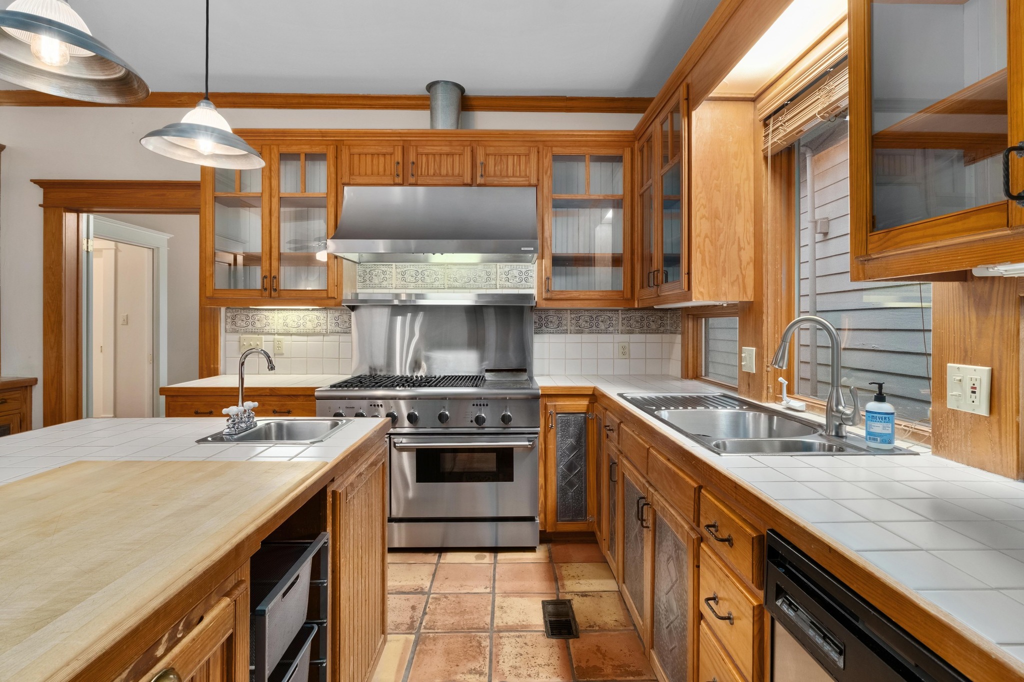 1502 Murray Lane Austin, TX 78703 - Photo 10 of 33 a kitchen with stainless steel appliances granite countertop a sink a stove and a wooden cabinets