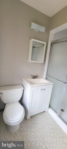a white toilet sitting next to a bathroom sink
