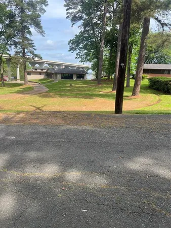 a view of yard with swimming pool and trees
