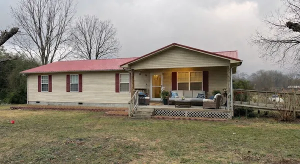 a view of a house with a bed and a yard