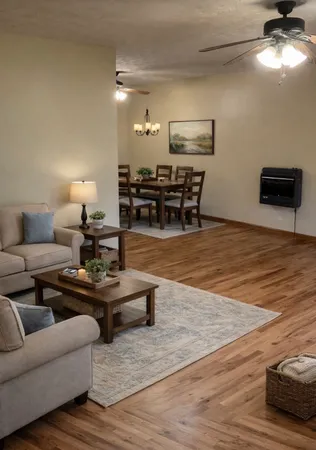 a living room with furniture and wooden floor