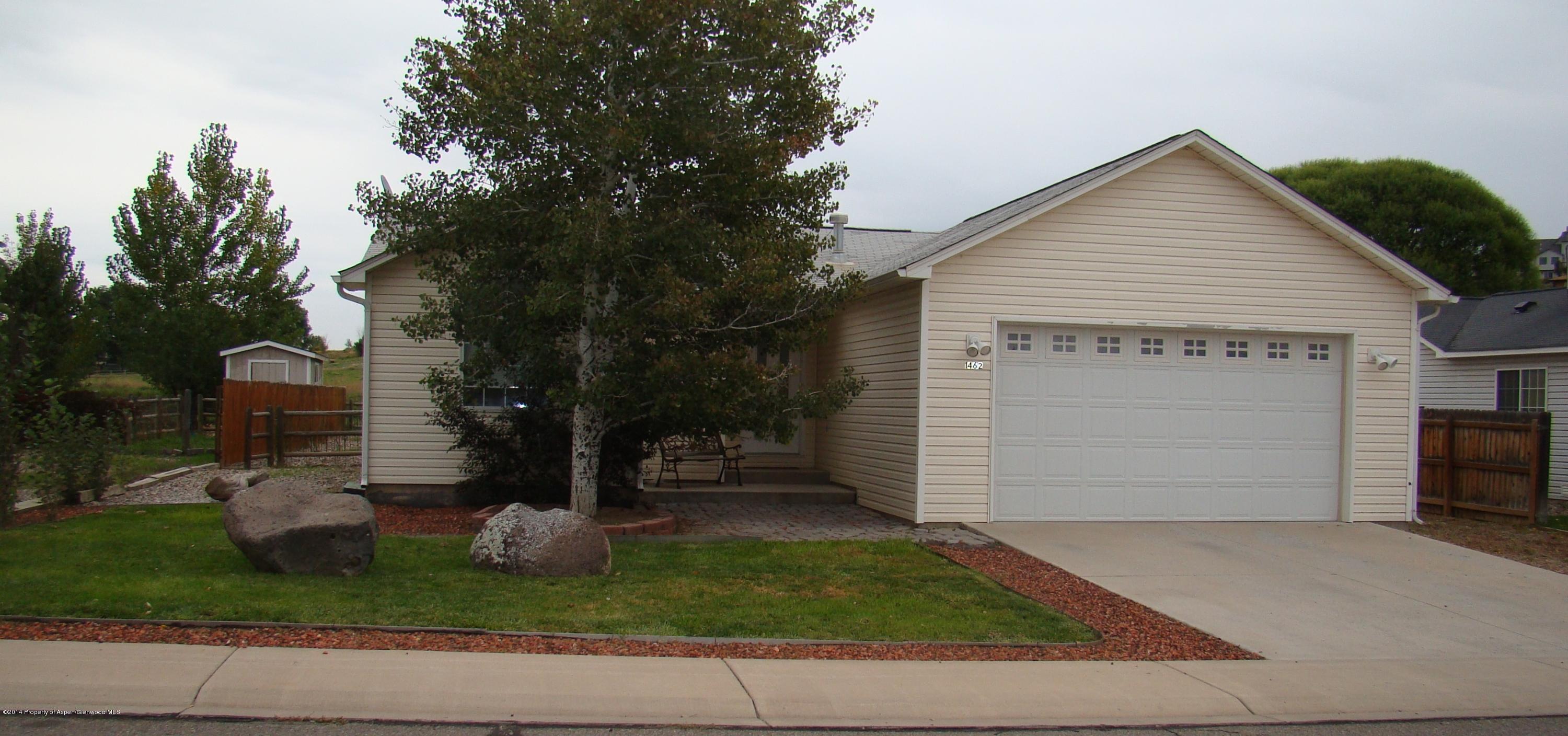 1462 Graham Court Rifle, CO 81650 - Photo 1 of 18 a front view of house with garage and yard