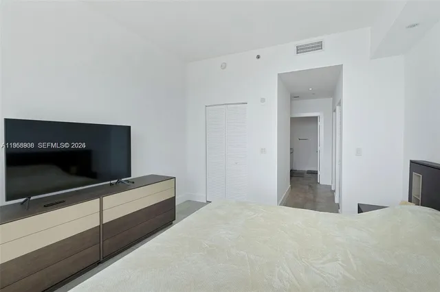 a bathroom with a tub a sink and a large mirror