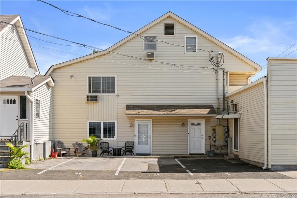 750 Cove Road, Unit 4 Stamford, CT 06902 - Photo 1 of 1 a front view of a house with a yard