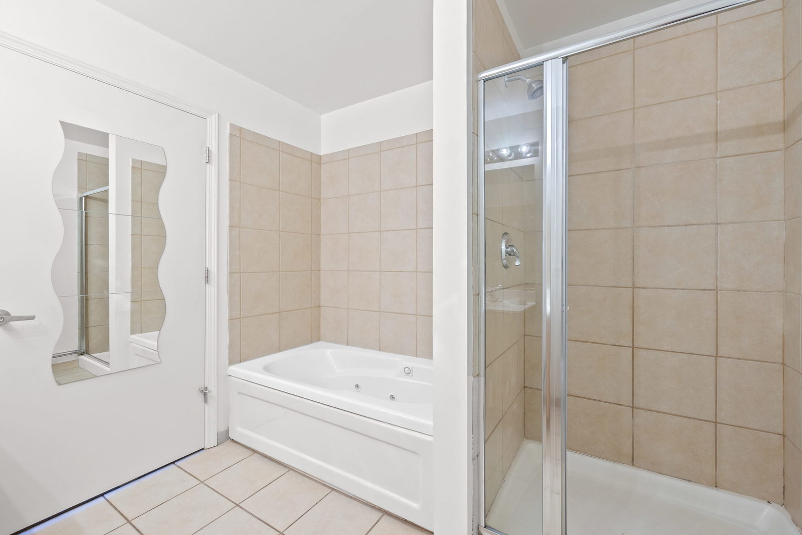 111 South Morgan Street, Unit 707 Chicago, IL 60607 - Photo 15 of 22 a bathroom with a bathtub and a shower