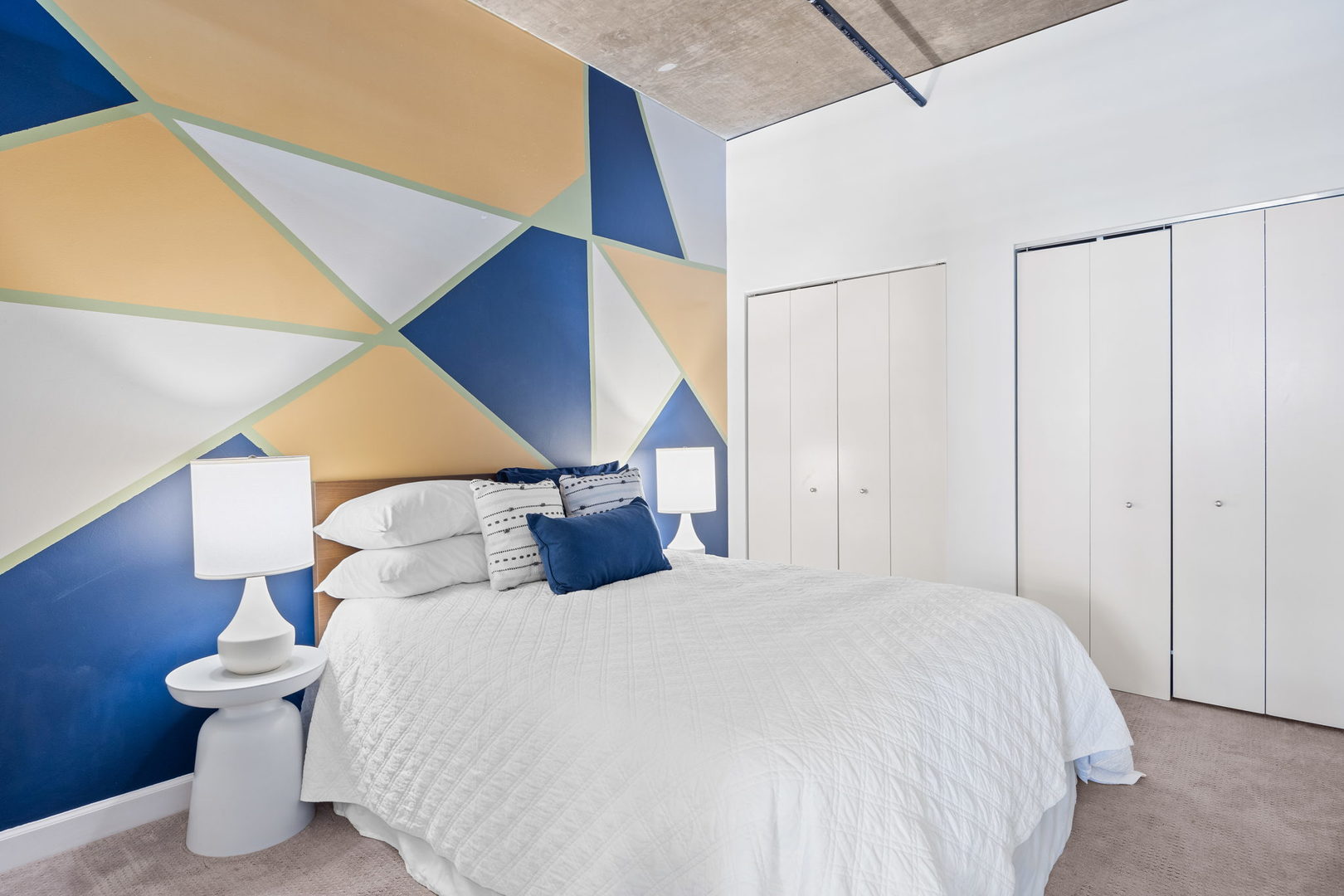 111 South Morgan Street, Unit 707 Chicago, IL 60607 - Photo 16 of 22 a bed room with a bed and a night stand