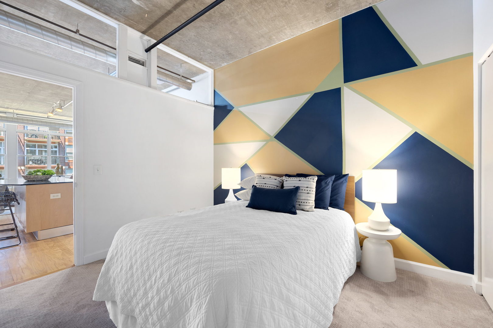 111 South Morgan Street, Unit 707 Chicago, IL 60607 - Photo 17 of 22 a bed room with a bed and a painting on the wall