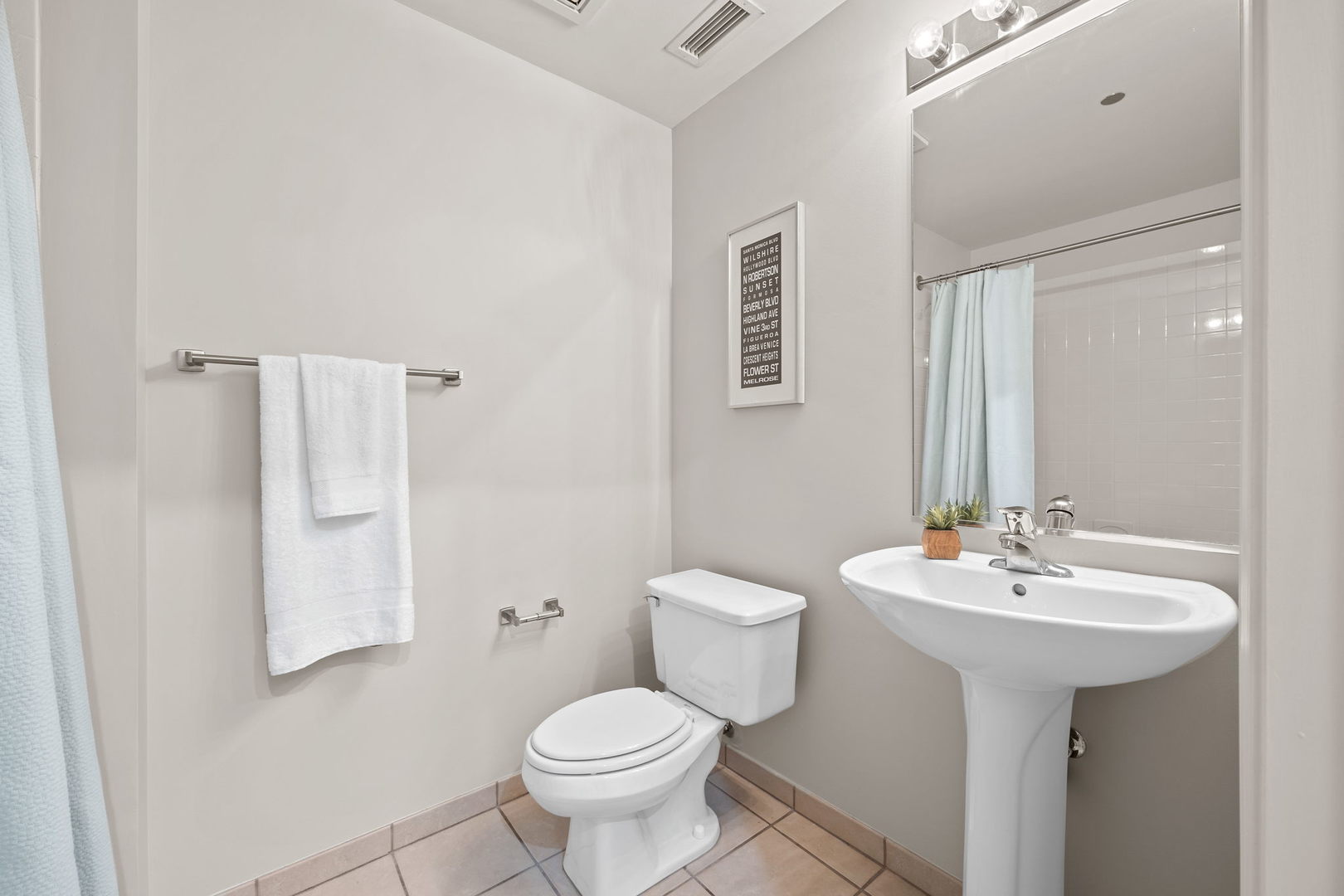 111 South Morgan Street, Unit 707 Chicago, IL 60607 - Photo 18 of 22 a bathroom with a sink toilet and mirror