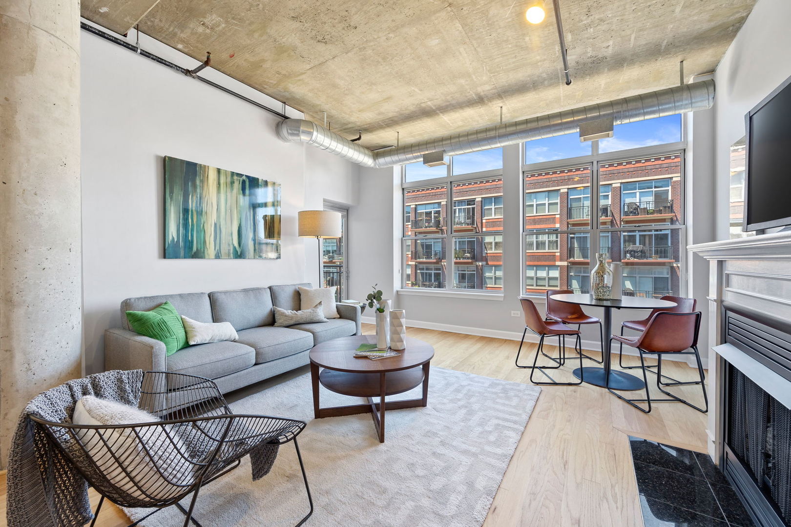 111 South Morgan Street, Unit 707 Chicago, IL 60607 - Photo 2 of 22 a living room with furniture and a fireplace
