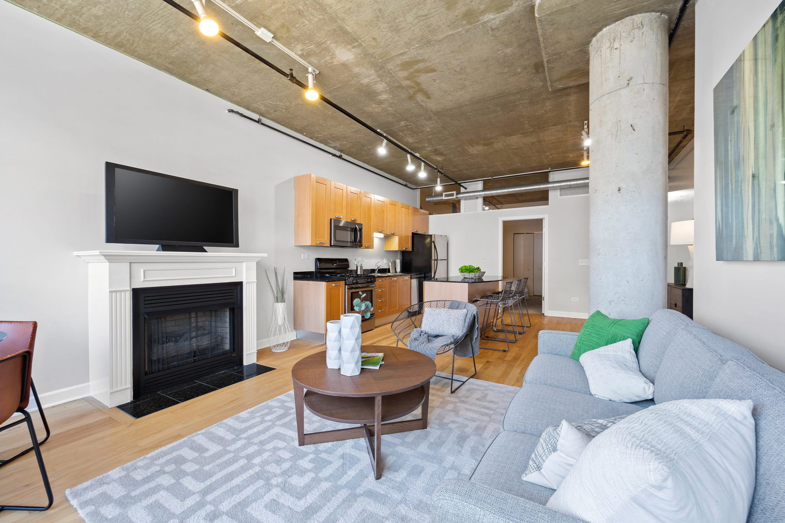 111 South Morgan Street, Unit 707 Chicago, IL 60607 - Photo 4 of 22 a living room with furniture a fireplace and a flat screen tv