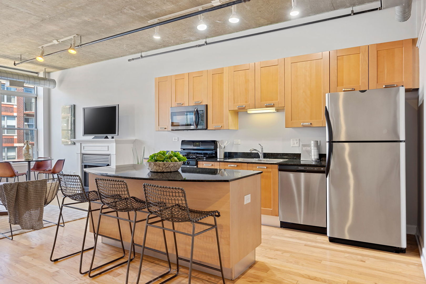 111 South Morgan Street, Unit 707 Chicago, IL 60607 - Photo 6 of 22 a kitchen with stainless steel appliances white cabinets and a refrigerator