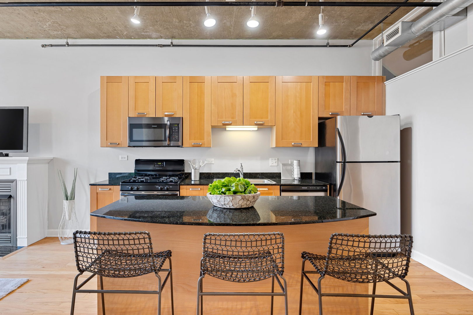 111 South Morgan Street, Unit 707 Chicago, IL 60607 - Photo 7 of 22 a kitchen with a refrigerator and a dining table