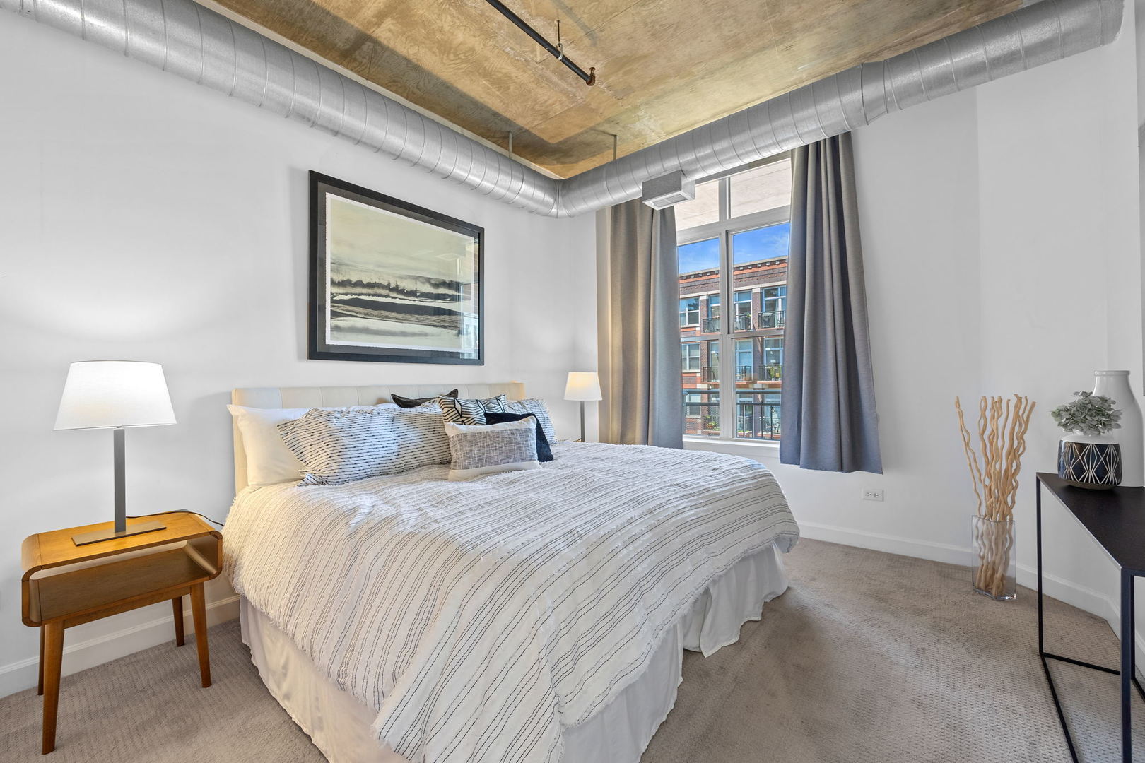 111 South Morgan Street, Unit 707 Chicago, IL 60607 - Photo 9 of 22 a bedroom with a bed and a lamp