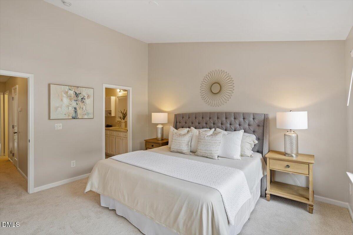 7734 Winners Edge Street Raleigh, NC 27617 - Photo 17 of 37 a bedroom with a bed and painting on the wall