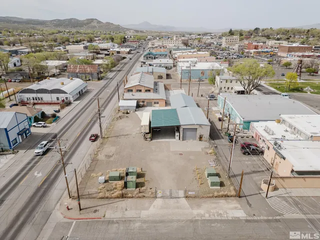 an aerial view of a houses with a city view