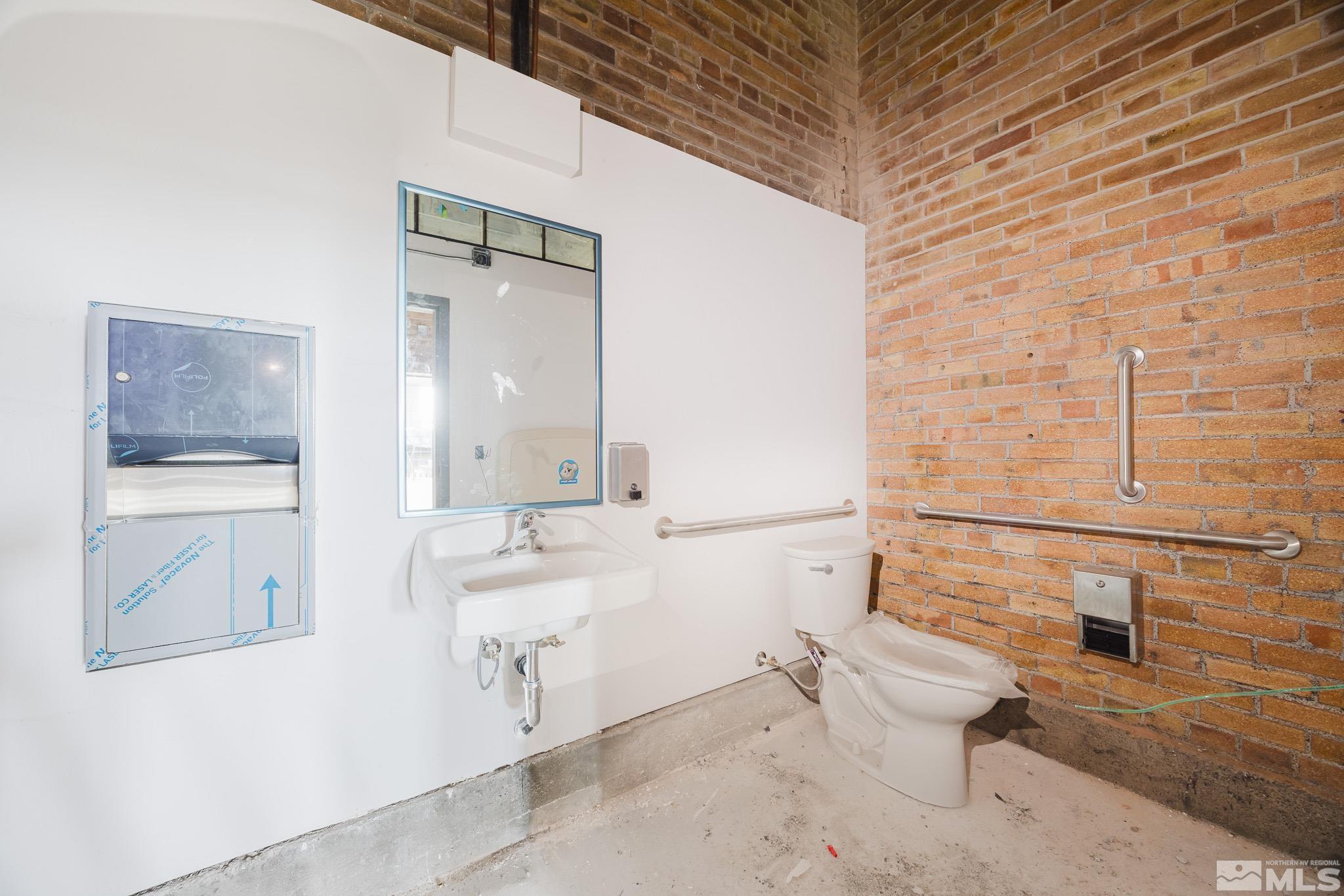 240 7th Street Elko, NV 89801 - Photo 24 of 40 a bathroom with a sink a toilet and mirror