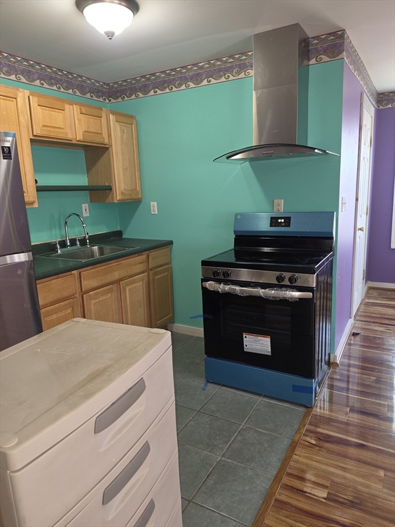 44-th 19th Street, Unit REAR Lowell, MA 01850 - Photo 8 of 13 a kitchen with cabinets and a stove top oven