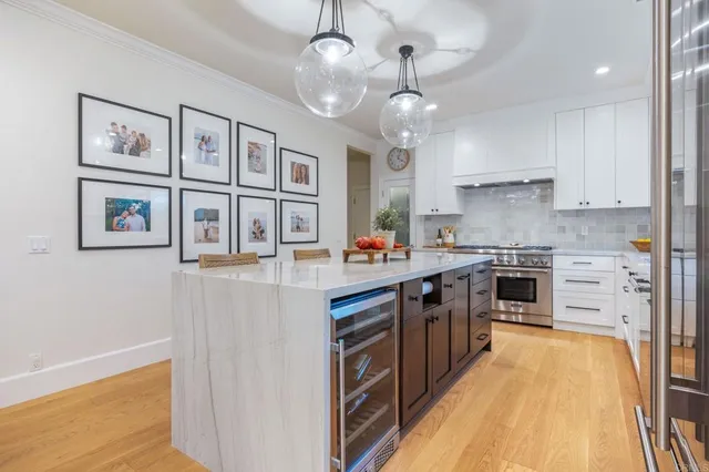 a kitchen with stainless steel appliances granite countertop a stove and cabinets