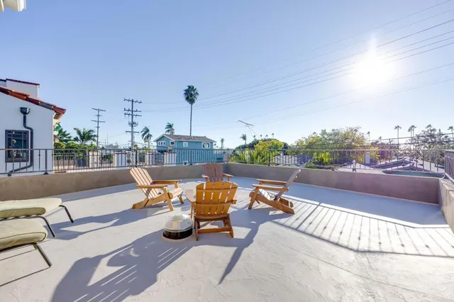 a view of a patio with table and chairs with wooden floor and fence