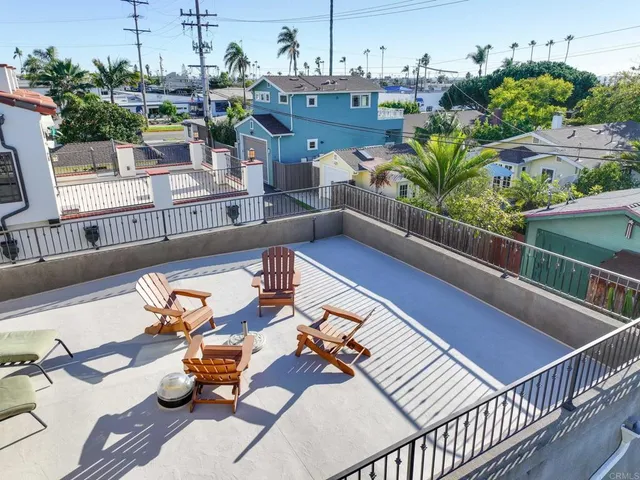 a view of a patio with couches table and chairs with potted plants
