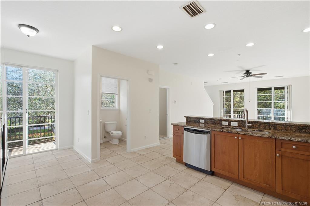 103 Cat Rock Lane Jupiter, FL 33458 - Photo 17 of 32 a kitchen with granite countertop a stove and a sink
