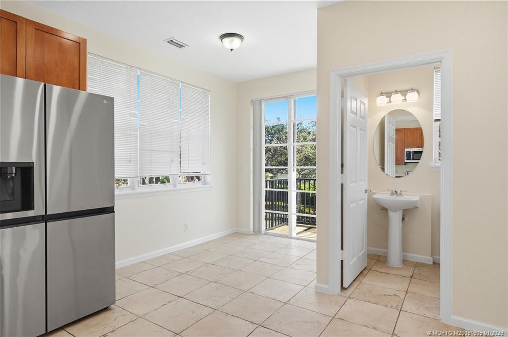 103 Cat Rock Lane Jupiter, FL 33458 - Photo 19 of 32 a view of a kitchen with refrigerator and more cabinets