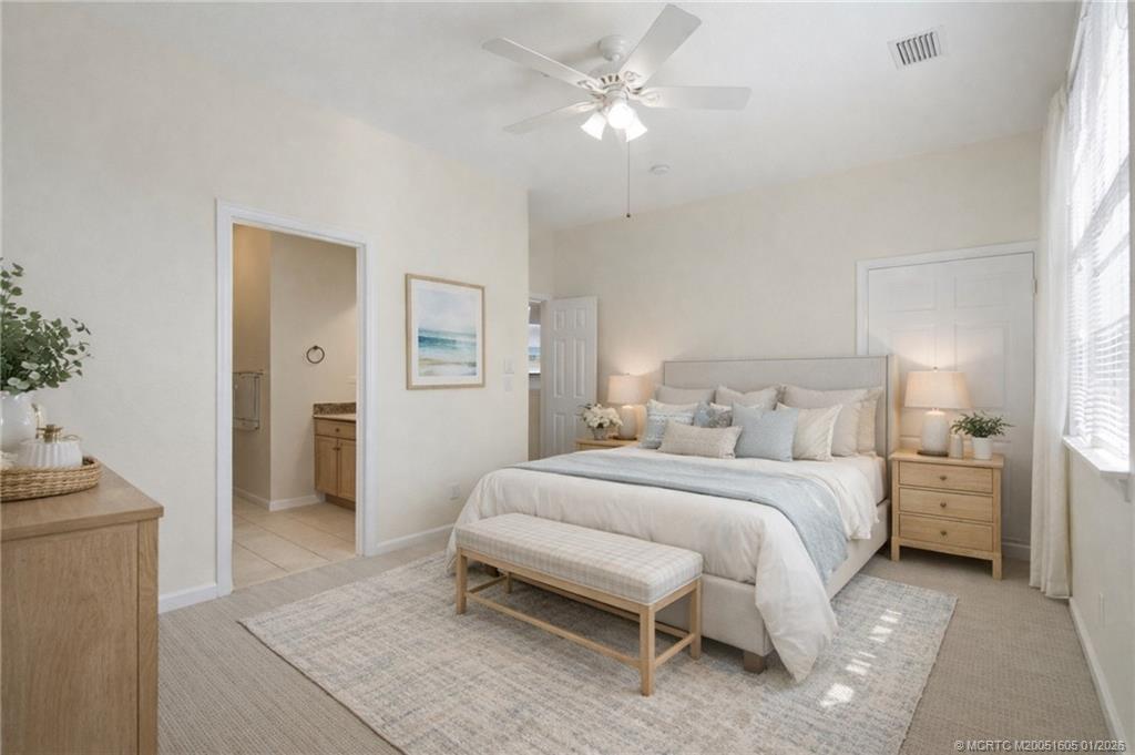 103 Cat Rock Lane Jupiter, FL 33458 - Photo 22 of 32 a bedroom with a bed and a chandelier