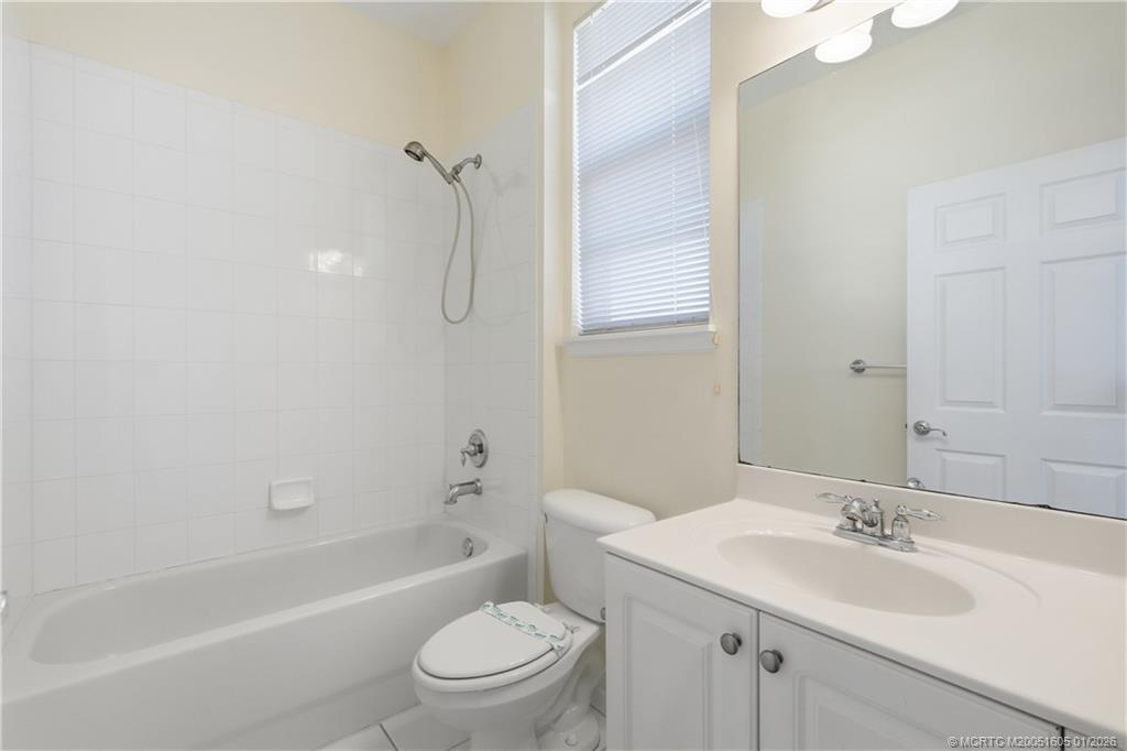 103 Cat Rock Lane Jupiter, FL 33458 - Photo 25 of 32 a bathroom with a granite countertop sink toilet and shower