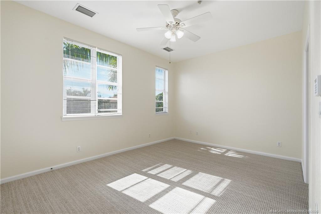 103 Cat Rock Lane Jupiter, FL 33458 - Photo 26 of 32 an empty room with windows and fan