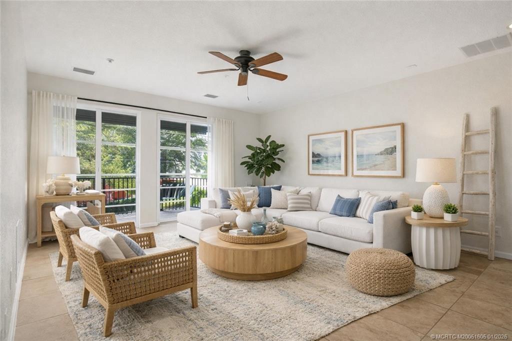 103 Cat Rock Lane Jupiter, FL 33458 - Photo 8 of 32 a living room with furniture and a large window