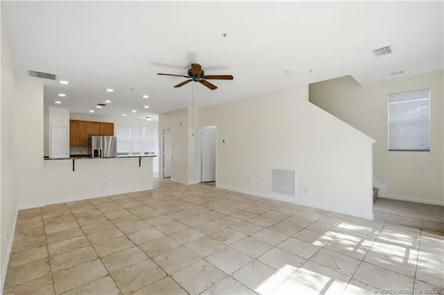 a kitchen with stainless steel appliances granite countertop a refrigerator and a stove top oven