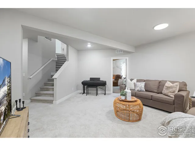 a living room with furniture and a dining table