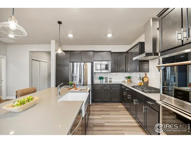 a kitchen with stainless steel appliances kitchen island granite countertop a sink and cabinets