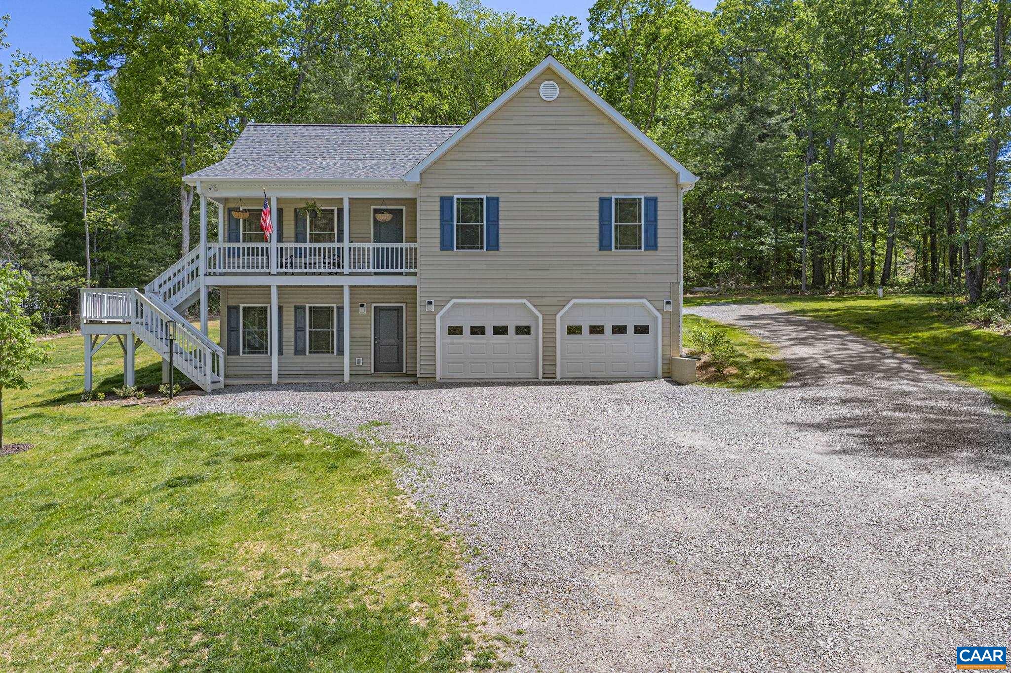 230 Fox Hollow Road Ruckersville, VA 22968 - Photo 5 of 42 a front view of a house with a yard and garage