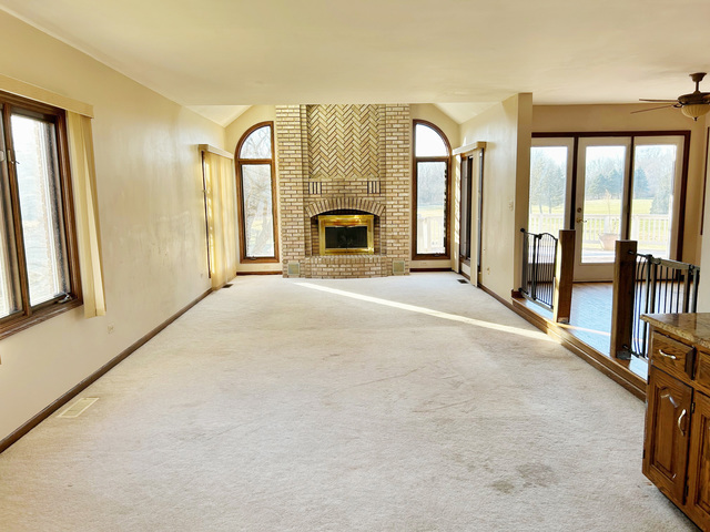 13043 West Regan Road Mokena, IL 60448 - Photo 10 of 32 a view of an empty room with a fireplace and a large window
