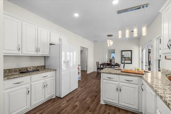 a kitchen with white cabinets and appliances