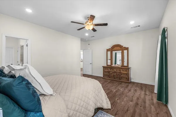 a bedroom with a bed dresser and a window