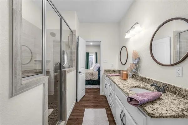 a view of bathroom with a toilet sink and mirror