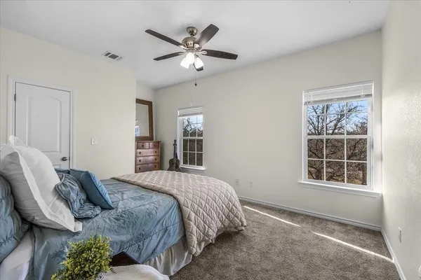 a bathroom with a granite countertop toilet sink and mirror