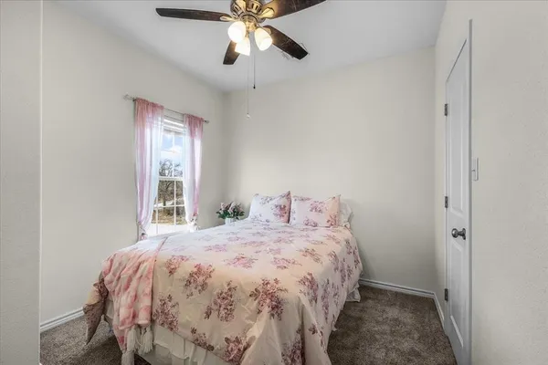 a bedroom with furniture and a window