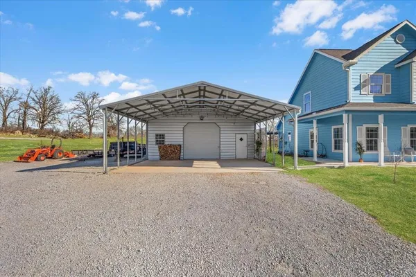 a backyard of a house with table and chairs