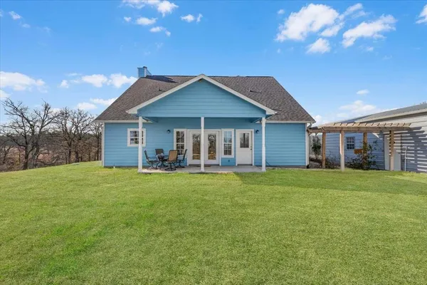an aerial view of a house with a yard