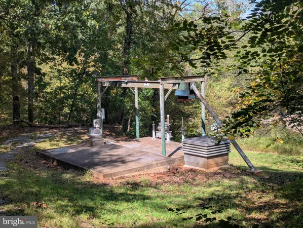 a backyard of a house with barbeque oven table and chairs