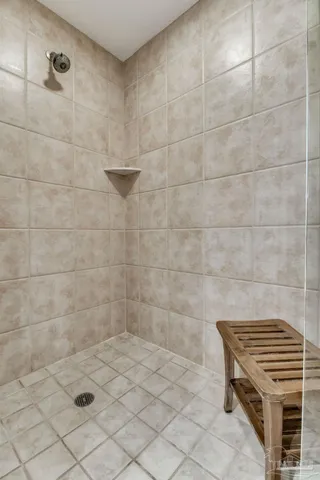 a bathroom with a white tub a sink and a window