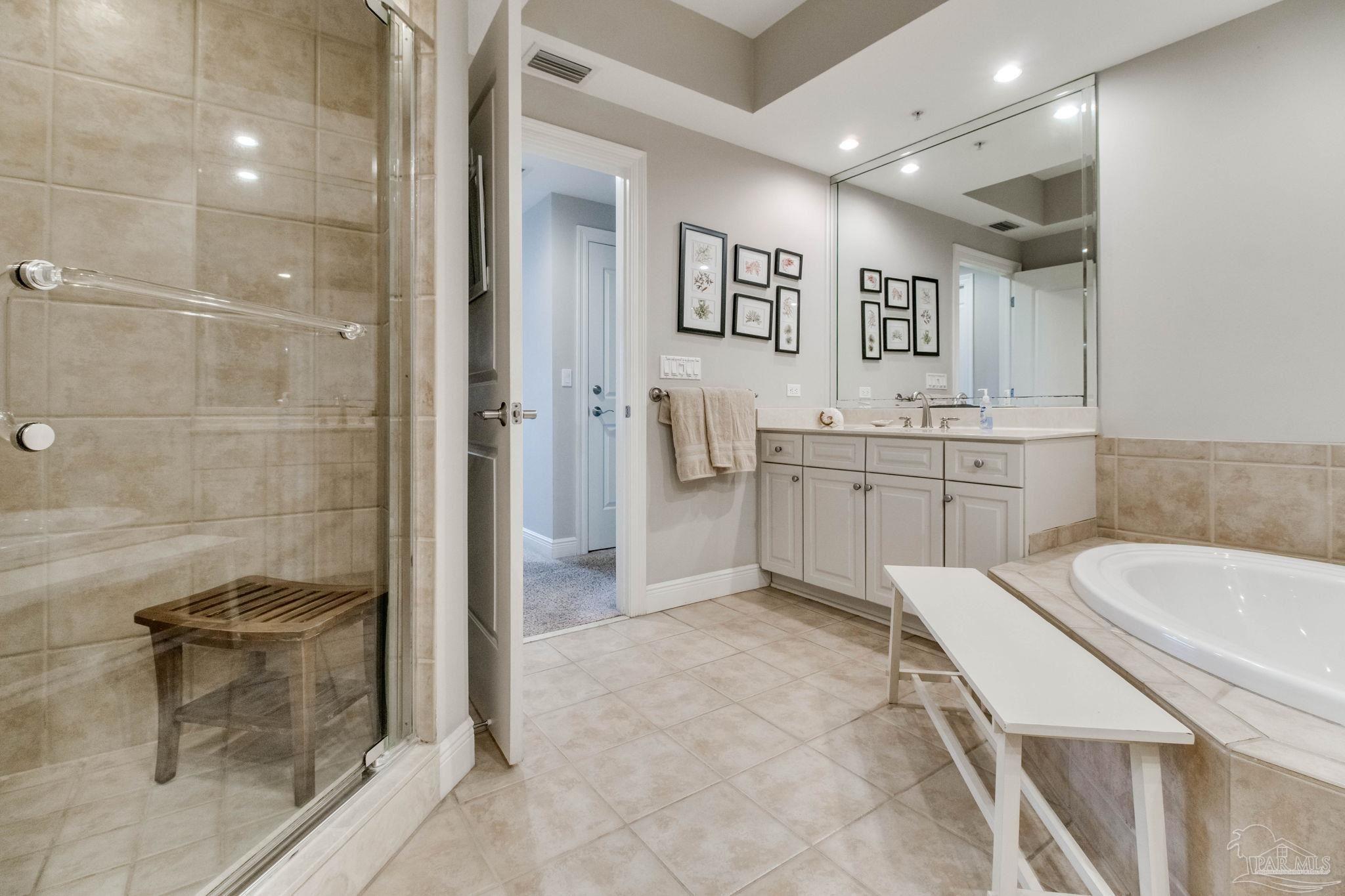 612 Lost Key Drive, Unit 405B Pensacola, FL 32507 - Photo 21 of 71 a spacious bathroom with a shower a sink and mirror