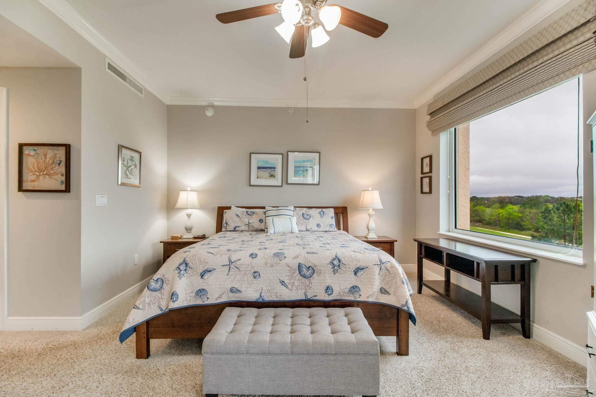 612 Lost Key Drive, Unit 405B Pensacola, FL 32507 - Photo 24 of 71 a bedroom with a bed and a large window